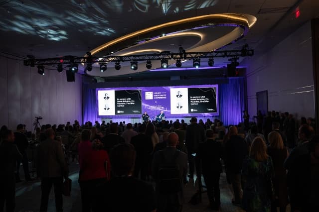 Audience watching a keynote session with Horst Schulze on the main stage at INSPIRE.