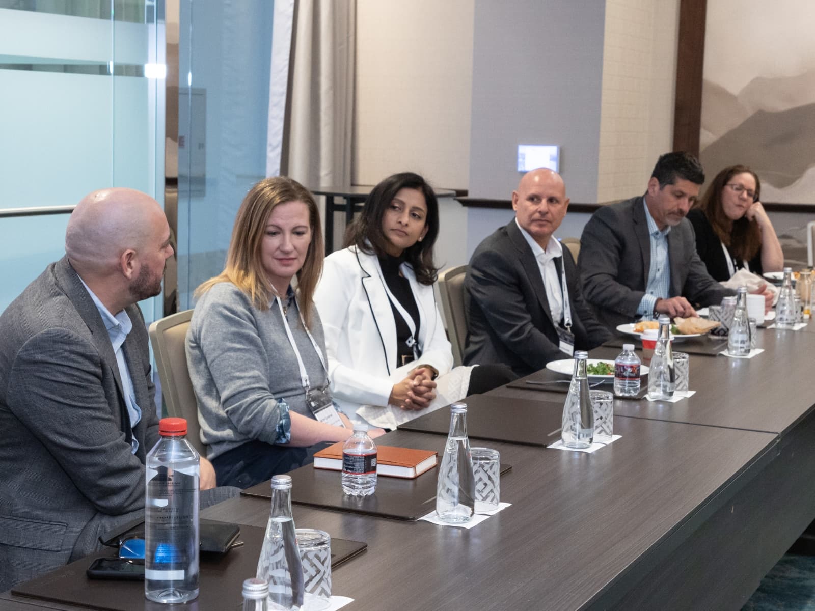 Panel of hospitality executives seated at a conference table.